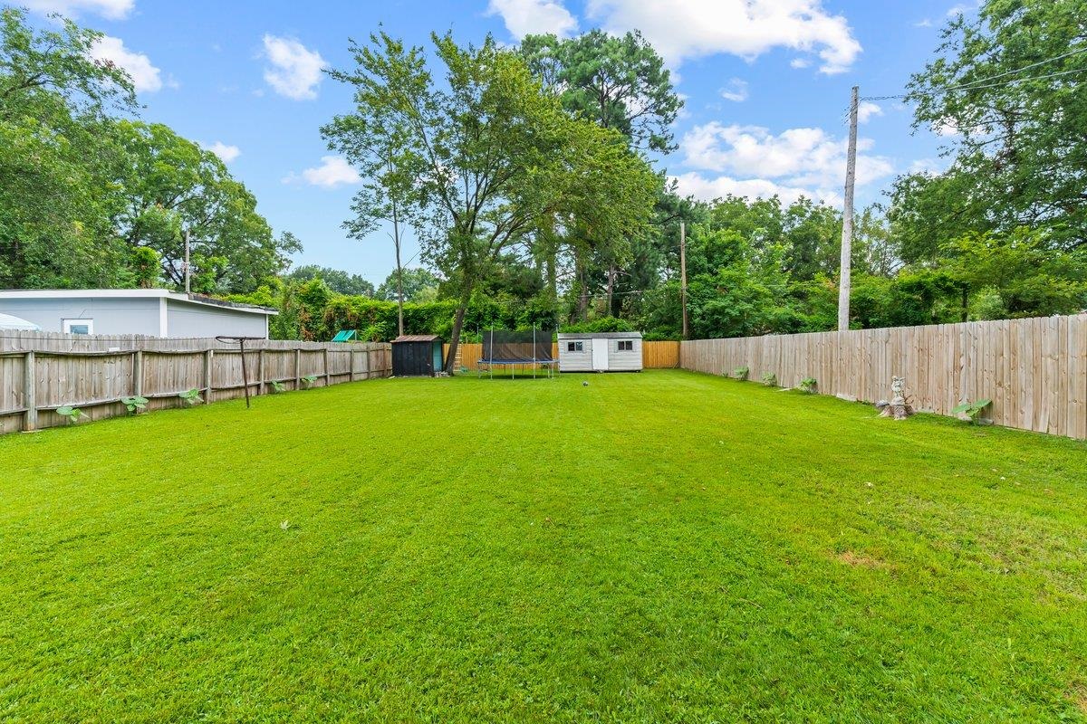 4740 Lynn Road Memphis, TN 38122 - Photo 22 of 25 a view of a house with a backyard and a patio