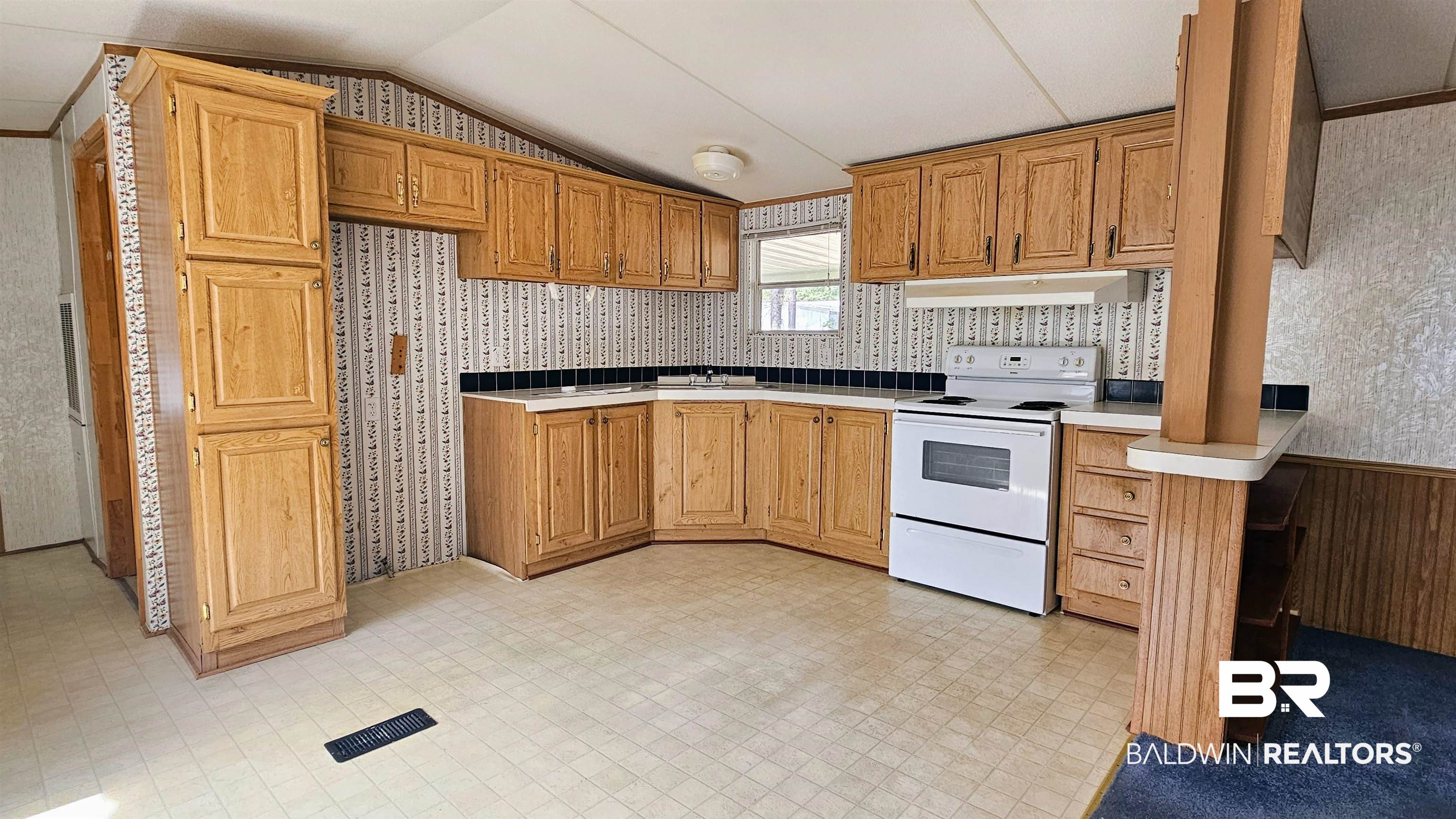 18659 Bull Springs Road Robertsdale, AL 36567 - Photo 4 of 25 Kitchen featuring white electric range, sink, and vaulted ceiling