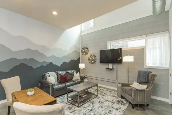 a living room with furniture and a flat screen tv