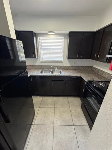 a kitchen with a sink and a stove top oven