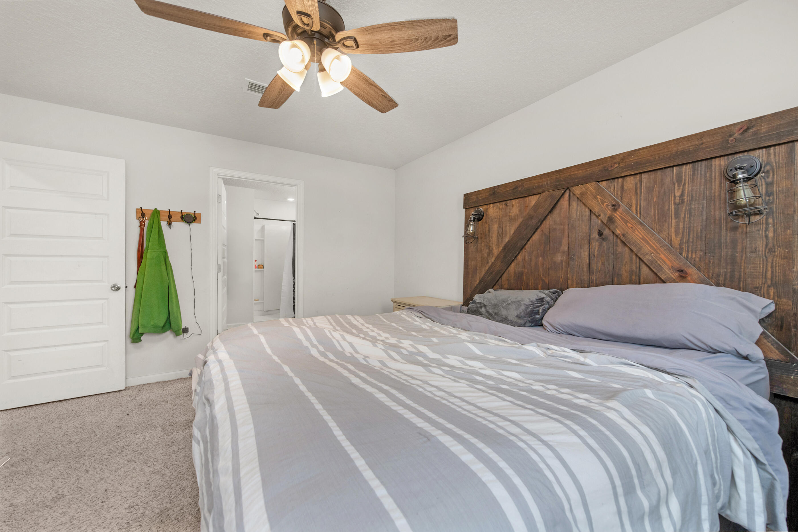 4662 Honor Guard Way Crestview, FL 32539 - Photo 5 of 10 a bedroom with a bed and a chandelier