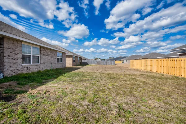 a view of house with backyard
