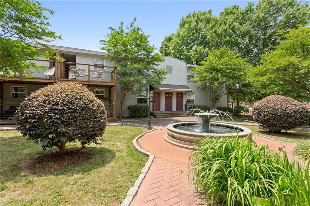 a view of a house with backyard swimming pool and sitting area