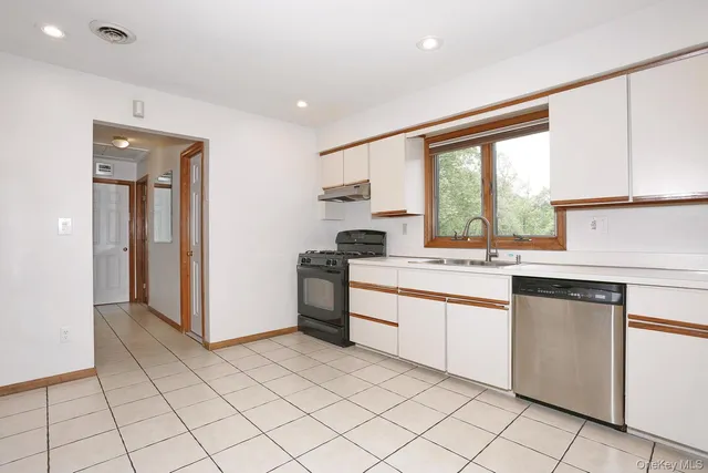 a kitchen with a sink cabinets and window