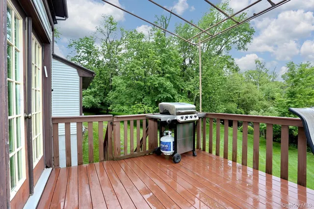 a view of balcony with wooden floor and outdoor seating