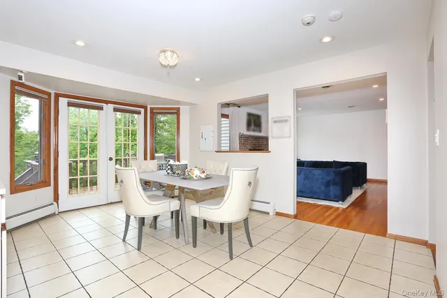 a dining room with furniture and wooden floor