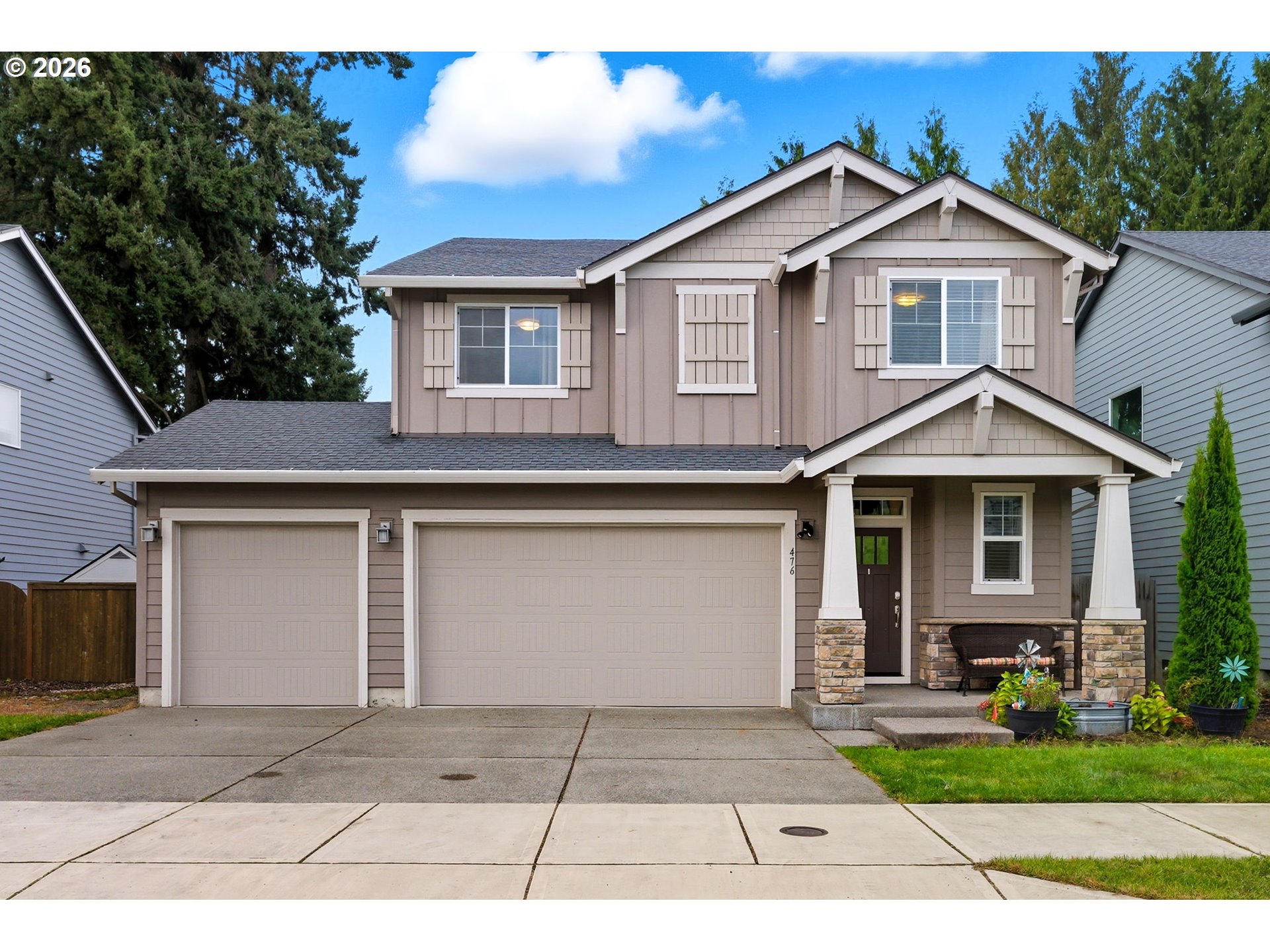 476 Southwest 15th Avenue Canby, OR 97013 - Photo 2 of 41 a front view of a house with a garden and trees