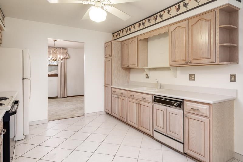 1110 Roxbury Close Rockford, IL 61107 - Photo 8 of 36 a kitchen with stainless steel appliances granite countertop a sink and a refrigerator