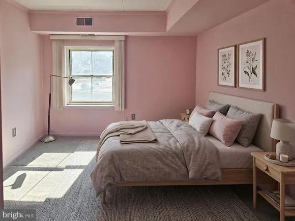 a bedroom with bed and a window