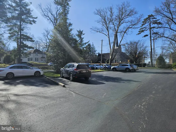 a view of road with parked cars