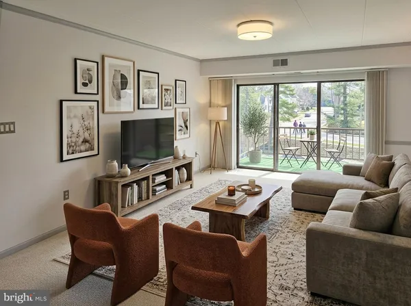 a living room with furniture flat screen tv and a large window