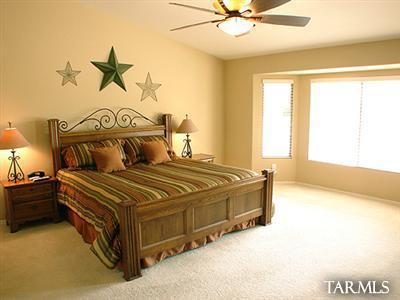 62195 East Northwood Road Tucson, AZ 85739 - Photo 16 of 25 a spacious bedroom with a bed and window