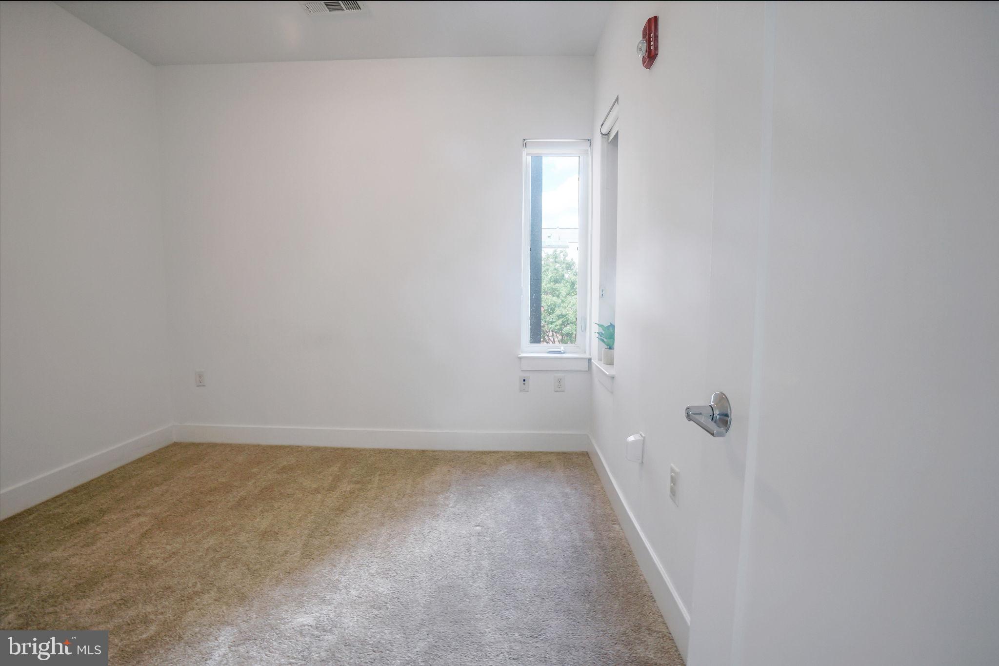 1111 Orren Street Northeast, Unit 310 Washington, DC 20002 - Photo 9 of 26 a view of an empty room with a window