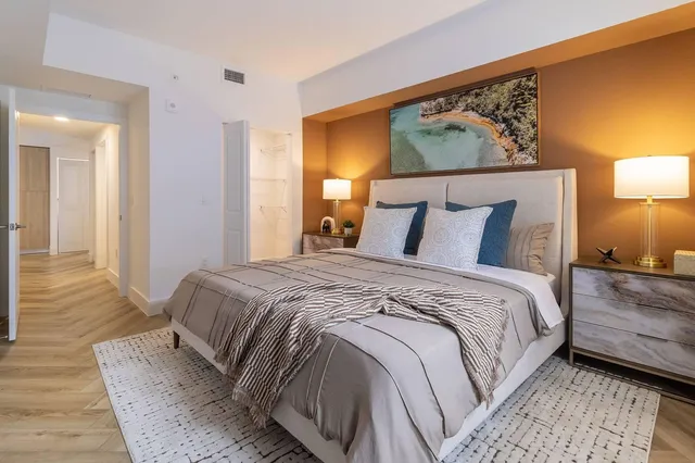 a bedroom with a bed and wooden floor