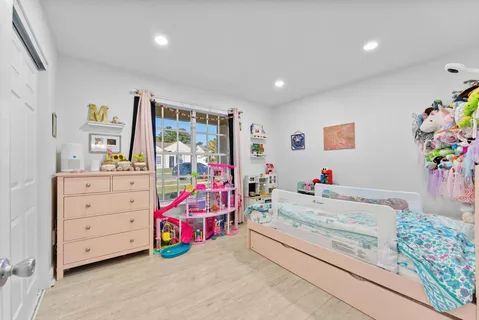 a bedroom with furniture and a baby crib