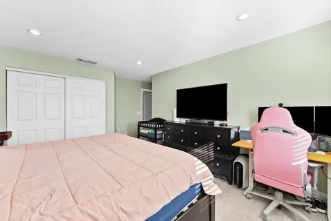 a bedroom with a bed and a flat screen tv