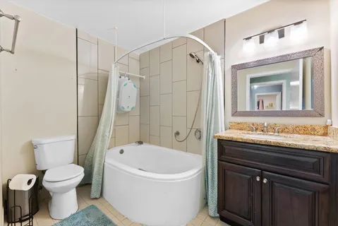 a bathroom with a sink a toilet and a mirror