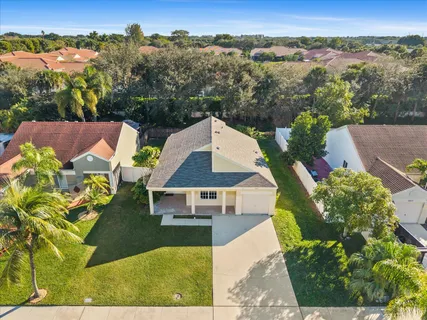 an aerial view of a house with yard swimming pool and mountain view