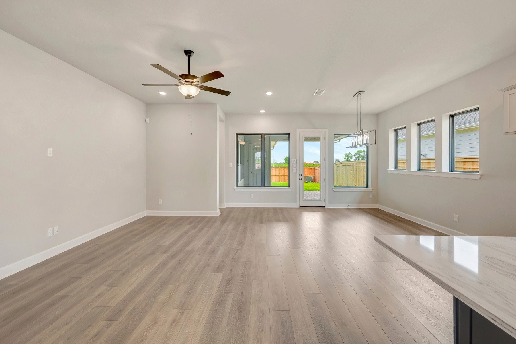 2722 Cottage Place Rosharon, TX 77583 - Photo 20 of 50 a view of an empty room with window and wooden floor