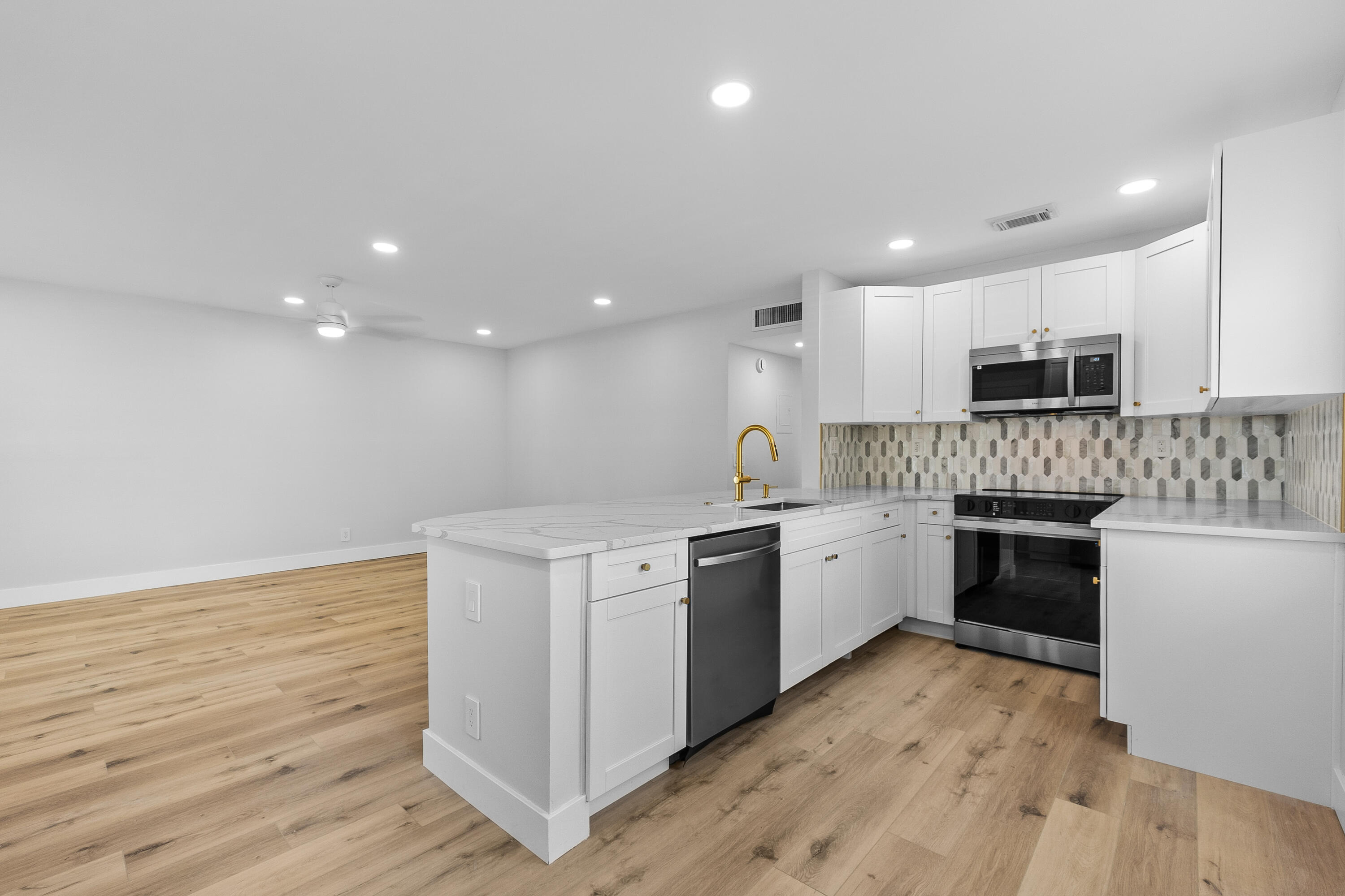 a kitchen with granite countertop white cabinets and white appliances