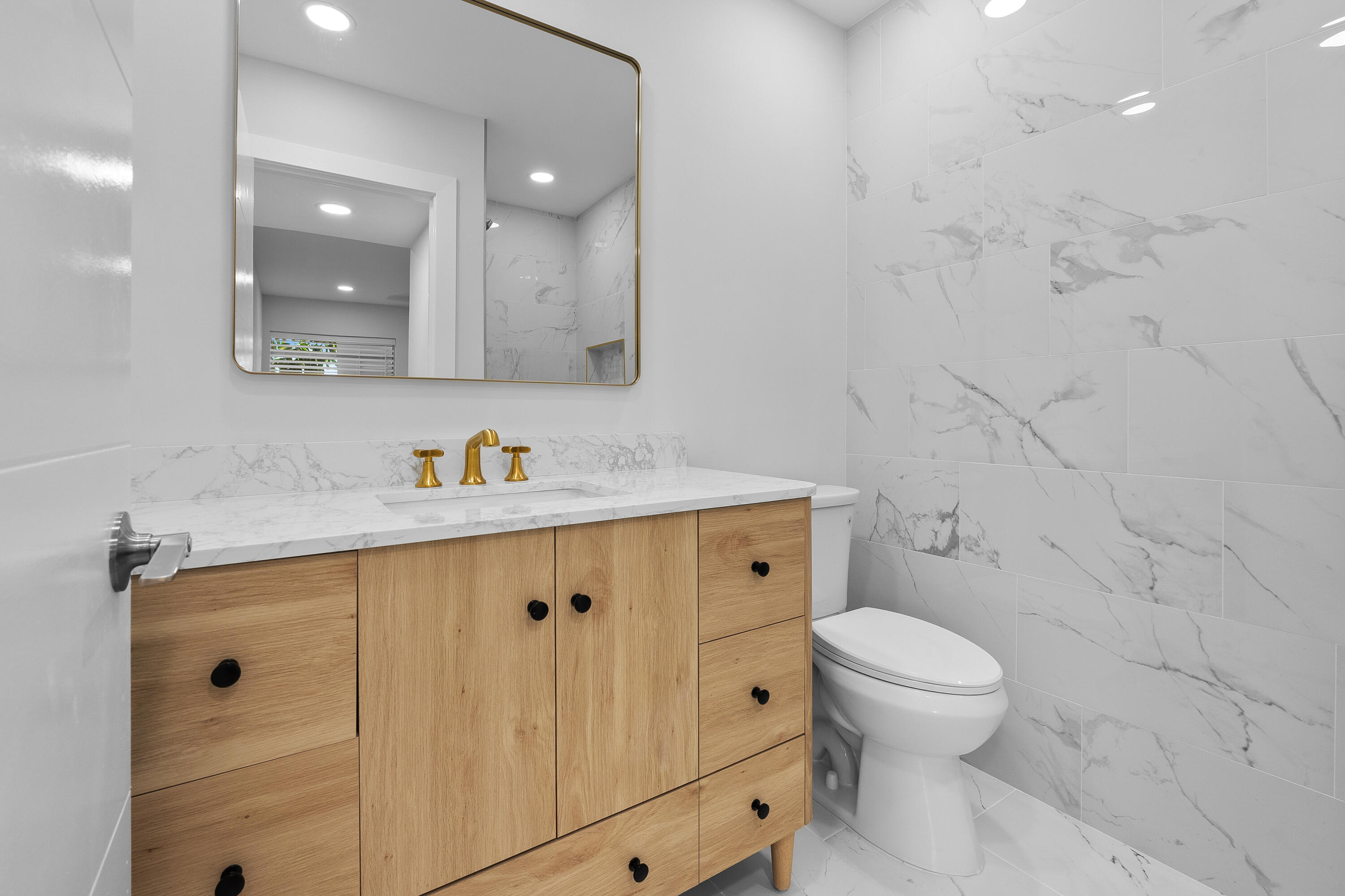 314 Monaco Boulevard, Unit G Delray Beach, FL 33446 - Photo 13 of 26 a bathroom with a granite countertop sink toilet and shower