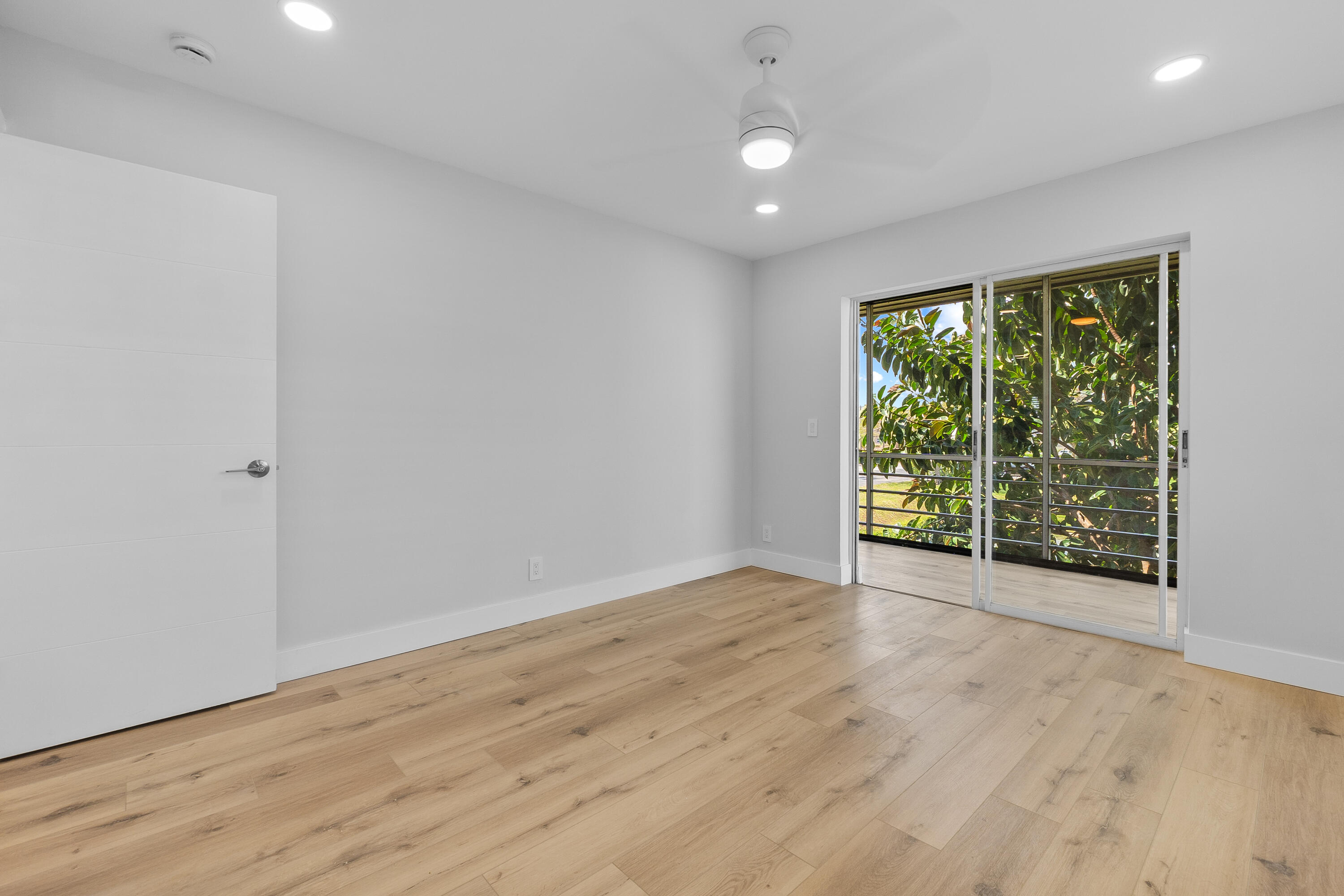 314 Monaco Boulevard, Unit G Delray Beach, FL 33446 - Photo 17 of 26 a view of an empty room with wooden floor and a window