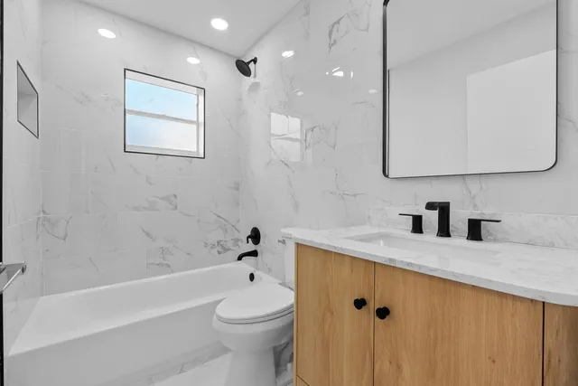 a en suite bathroom with a toilet sink and mirror