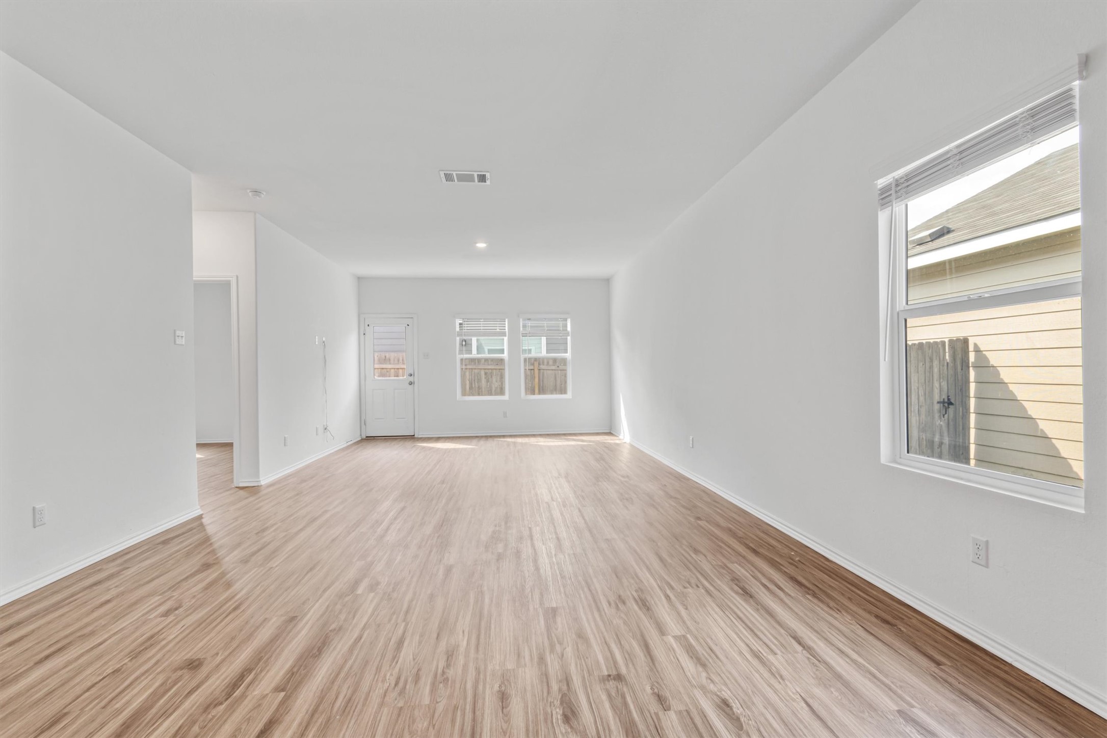 417 Soapstone Pass Maxwell, TX 78656 - Photo 11 of 18 a view of an empty room with wooden floor and a window