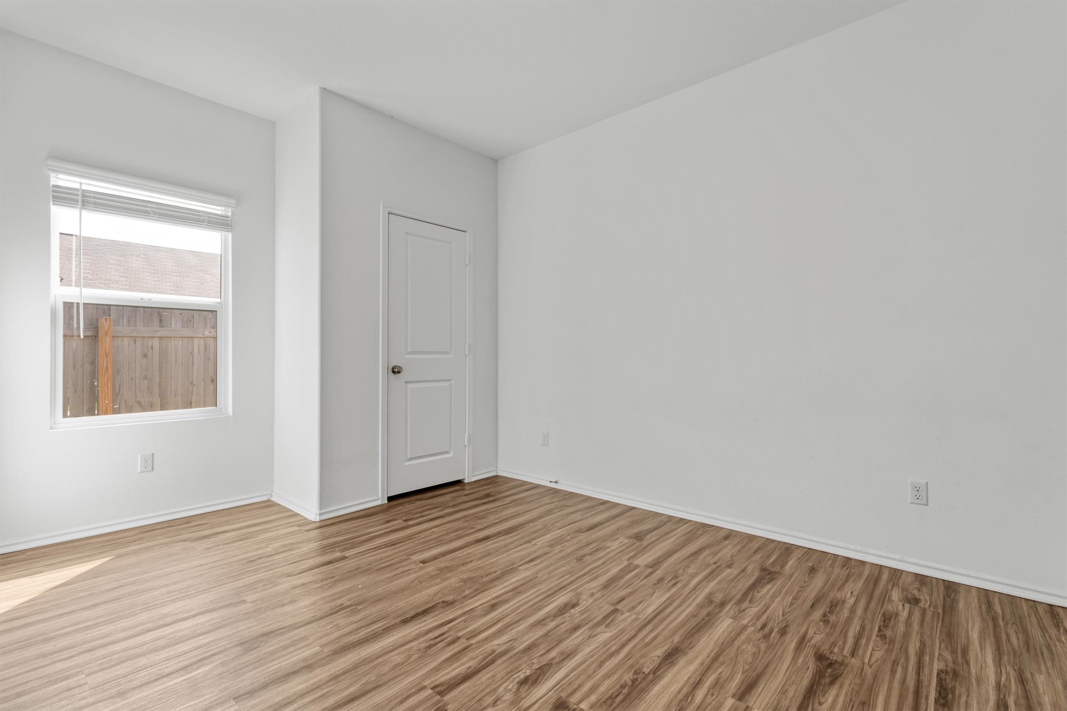 417 Soapstone Pass Maxwell, TX 78656 - Photo 15 of 18 an empty room with wooden floor and windows