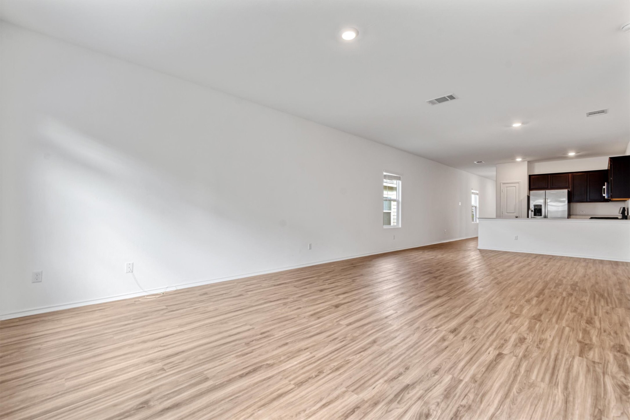 417 Soapstone Pass Maxwell, TX 78656 - Photo 7 of 18 a view of an empty room with wooden floor and a window