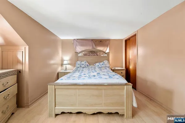 a bedroom with a bed and a chair