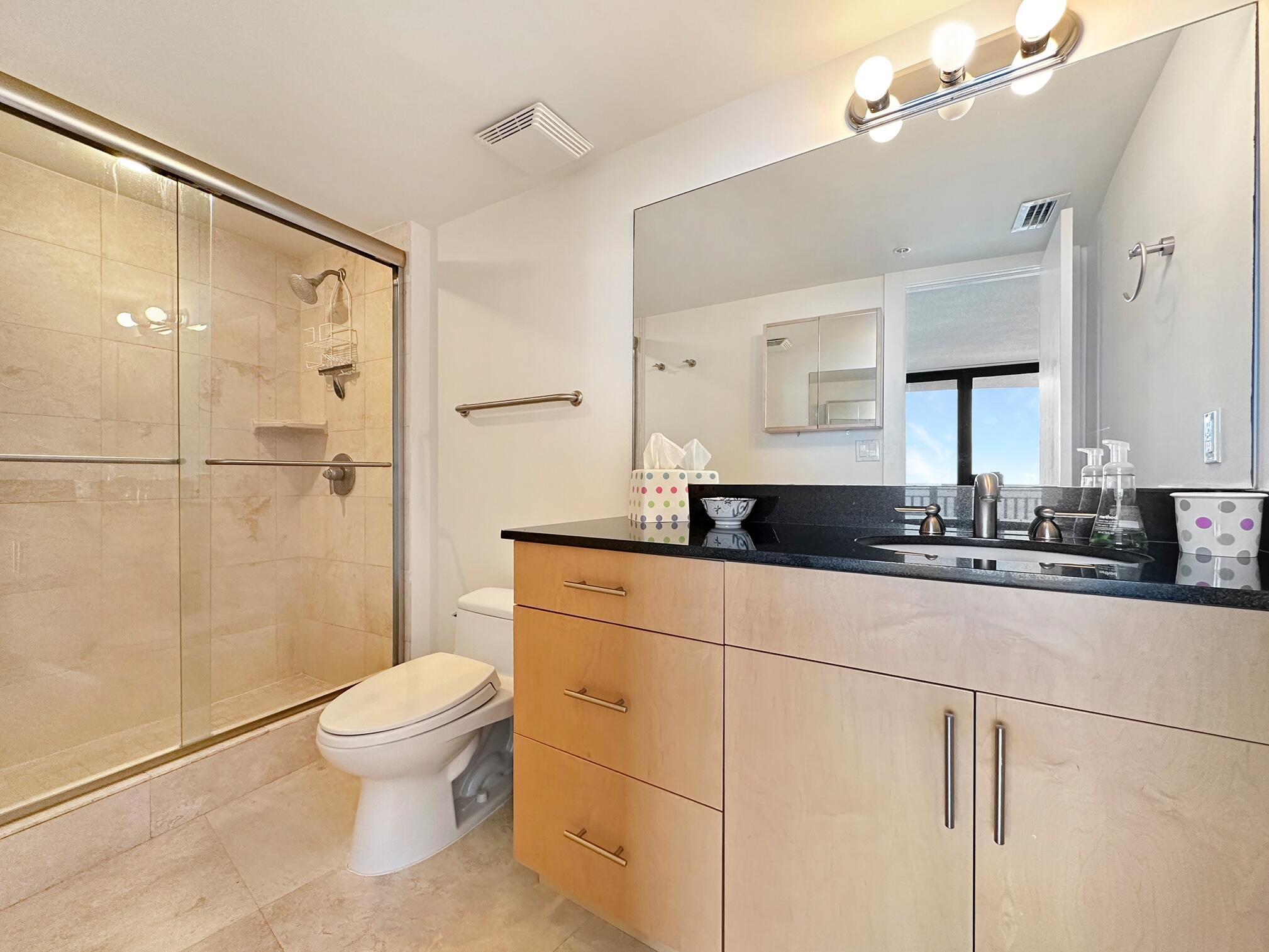 3000 North Ocean Drive, Unit 22D Riviera Beach, FL 33404 - Photo 11 of 53 a bathroom with a double vanity sink toilet and shower