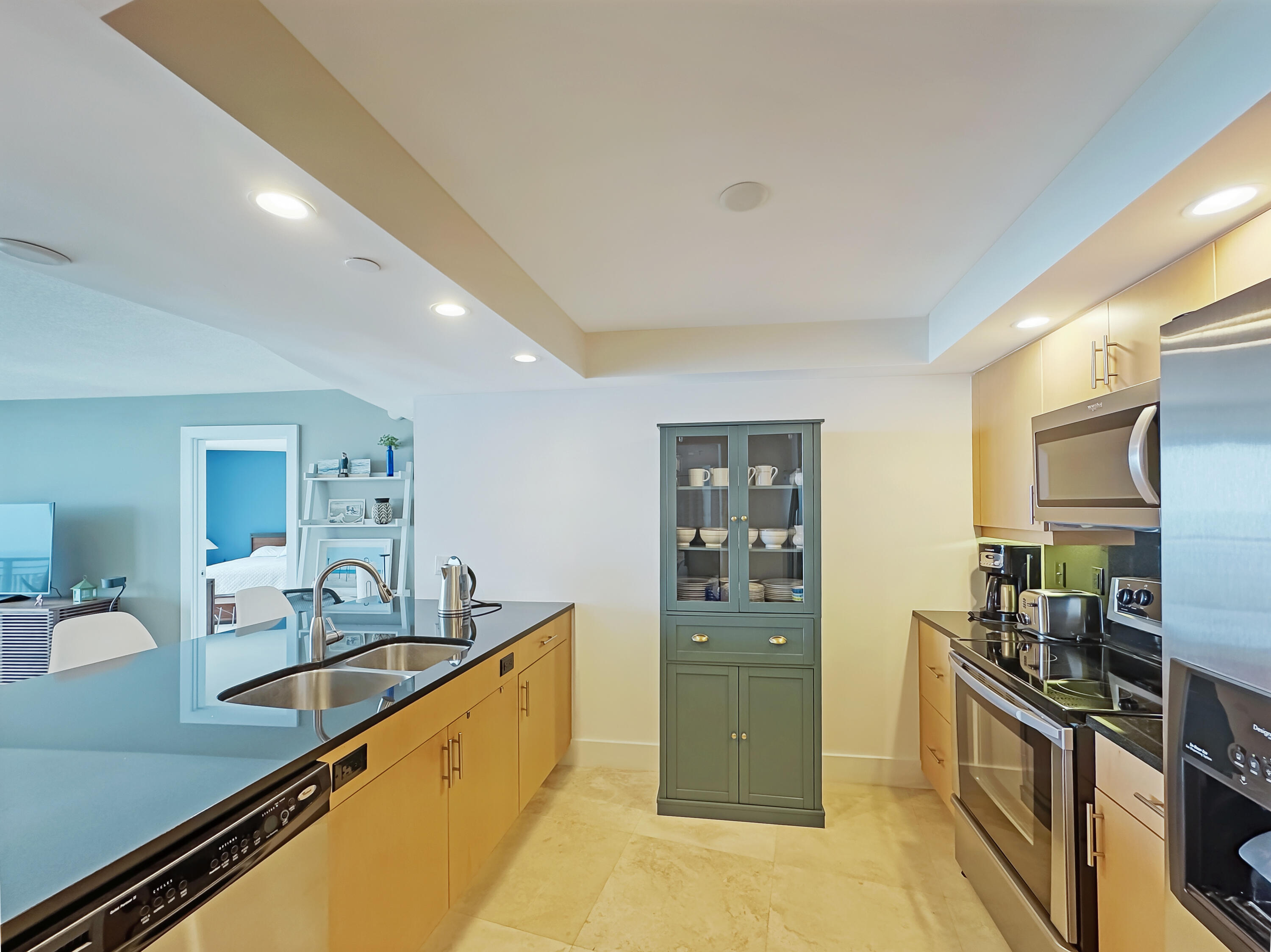 3000 North Ocean Drive, Unit 22D Riviera Beach, FL 33404 - Photo 6 of 53 a kitchen with stainless steel appliances granite countertop a sink stove and refrigerator
