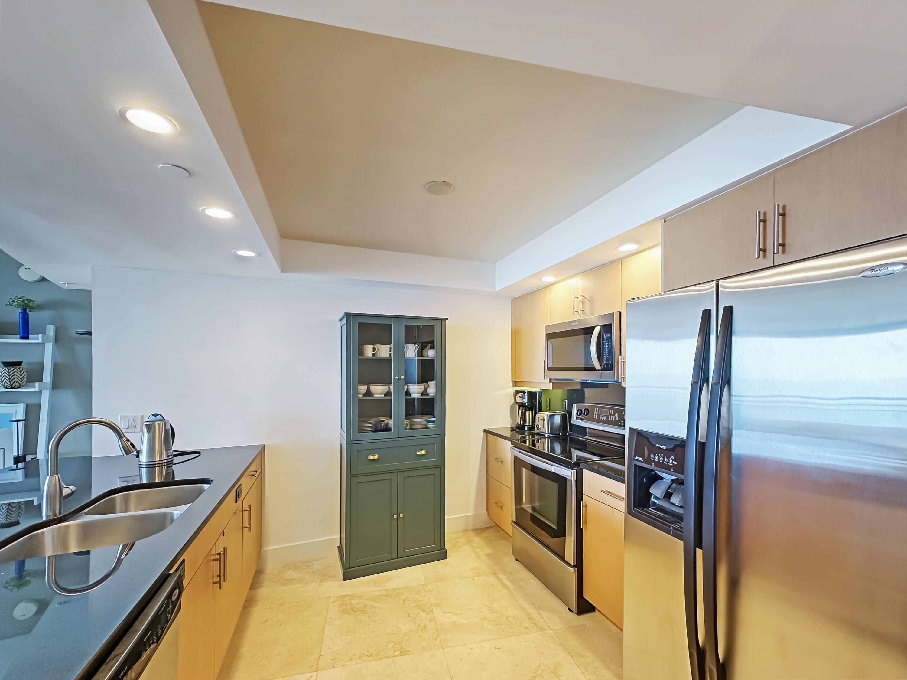 3000 North Ocean Drive, Unit 22D Riviera Beach, FL 33404 - Photo 7 of 53 a kitchen with stainless steel appliances granite countertop a sink stove and refrigerator