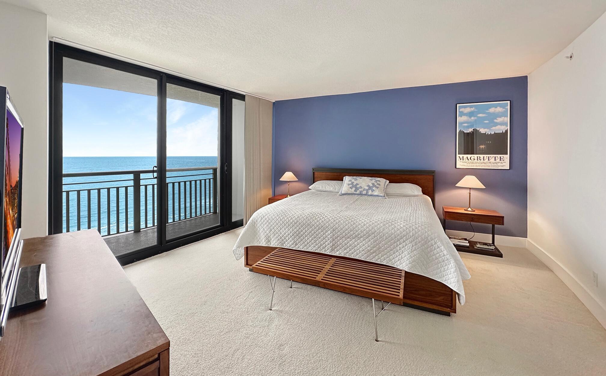 3000 North Ocean Drive, Unit 22D Riviera Beach, FL 33404 - Photo 9 of 53 a bedroom with a bed and a table in it