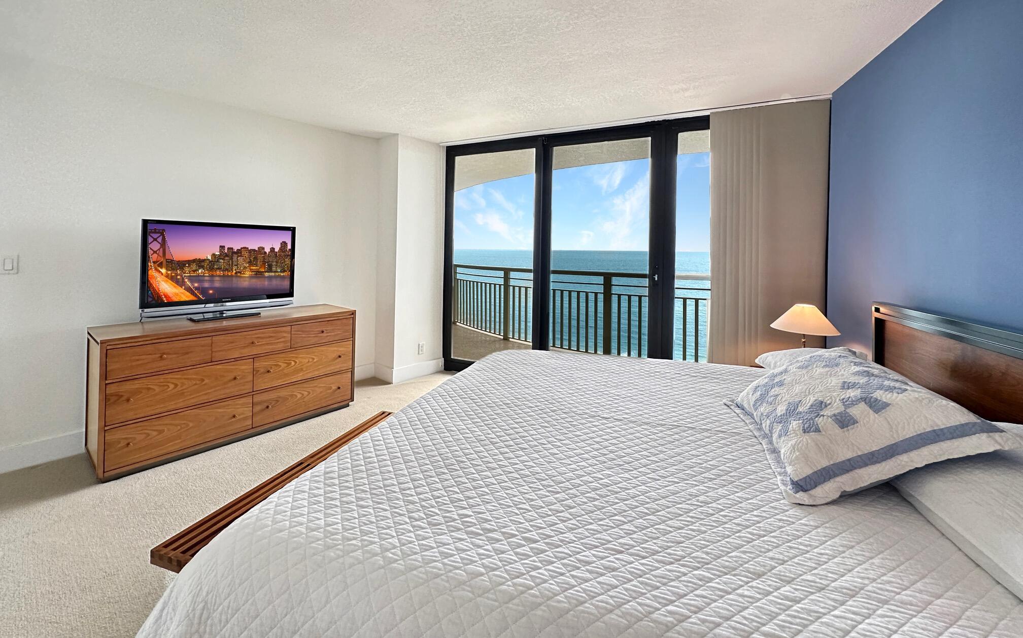 3000 North Ocean Drive, Unit 22D Riviera Beach, FL 33404 - Photo 10 of 53 a bedroom with a bed and a flat screen tv