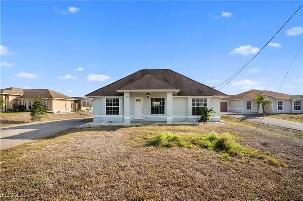 a front view of a house with a yard