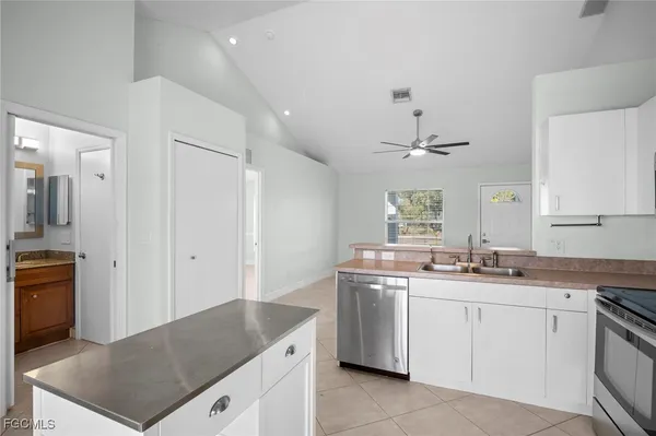 a kitchen with a sink stove top oven and cabinets