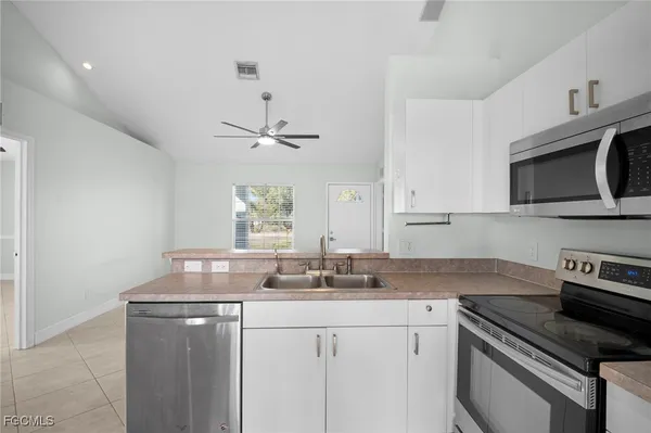 a kitchen with a sink stove and microwave