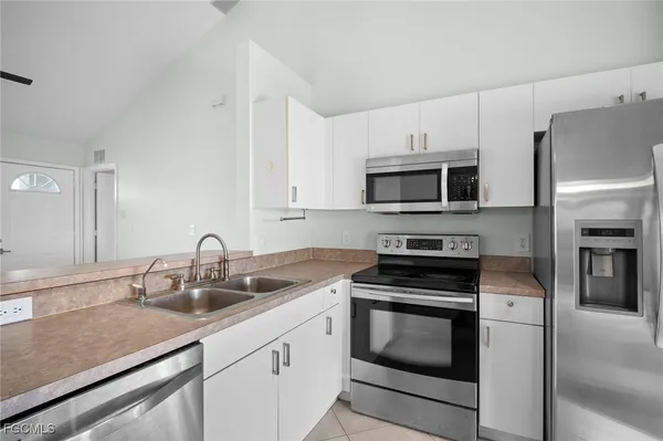 a kitchen with sink a microwave and stove