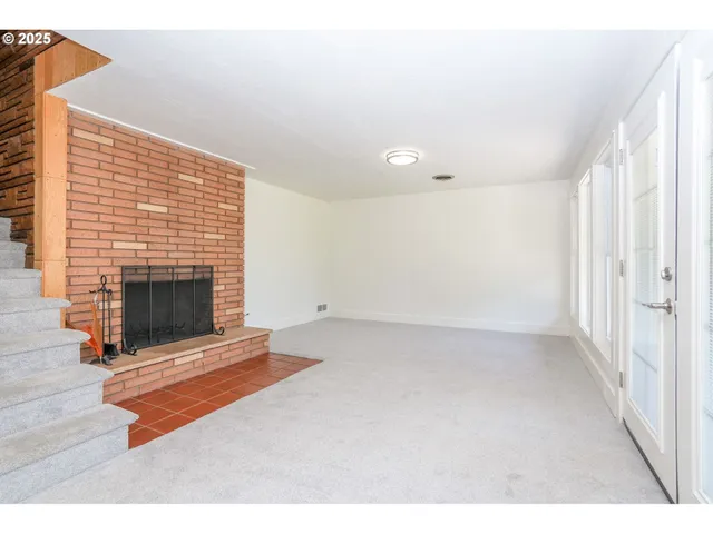 a living room with a fireplace furniture and a window