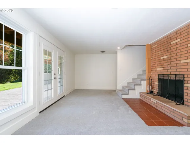 a view of an empty room with a fireplace