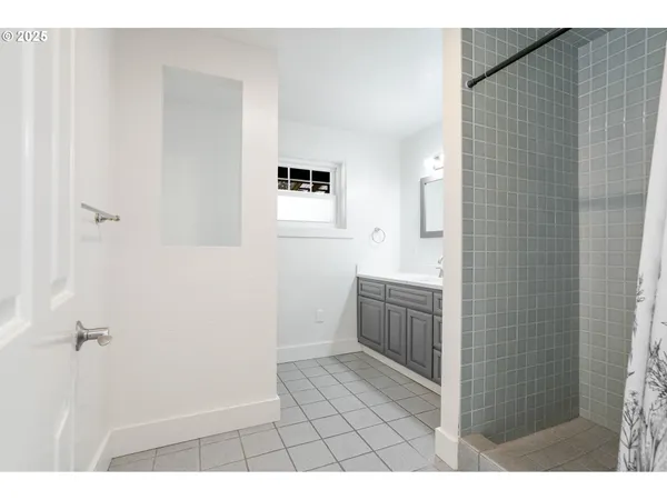 a bathroom with a sink a toilet a mirror and shower