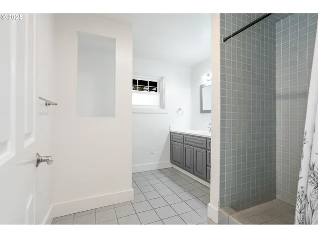 a bathroom with a sink a toilet a mirror and shower