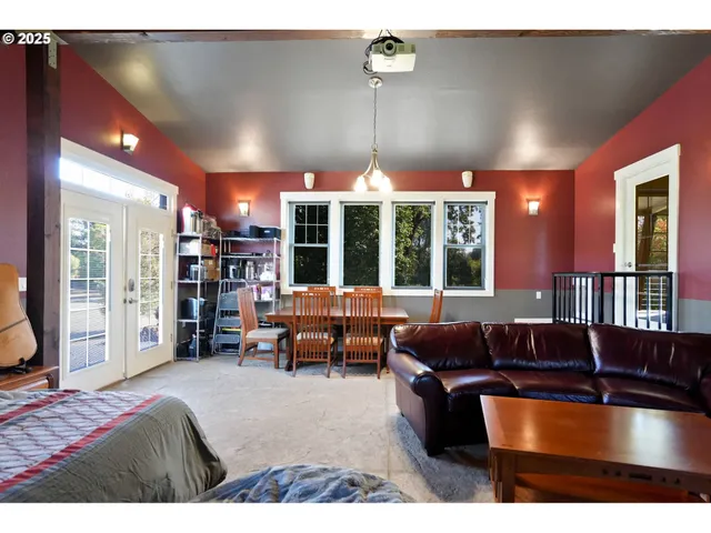 a living room with furniture a large window and chandelier