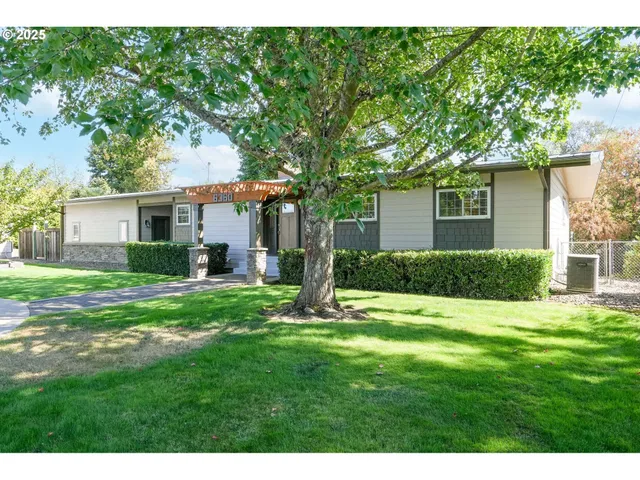 a view of a house with a yard and a garden