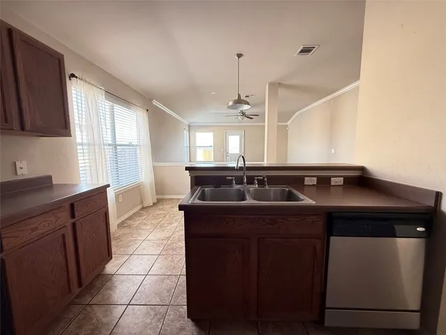 a kitchen with a stove sink and cabinets