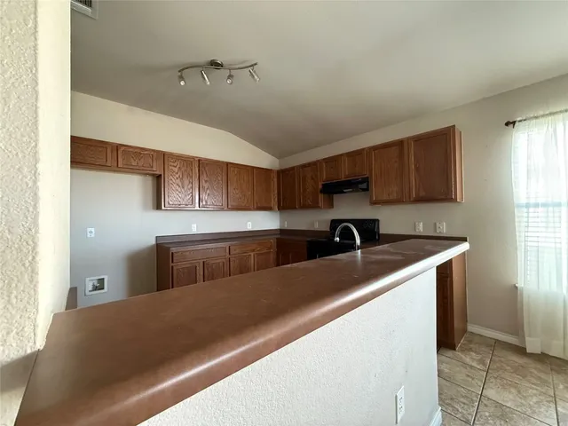 a kitchen with a cabinets and appliances