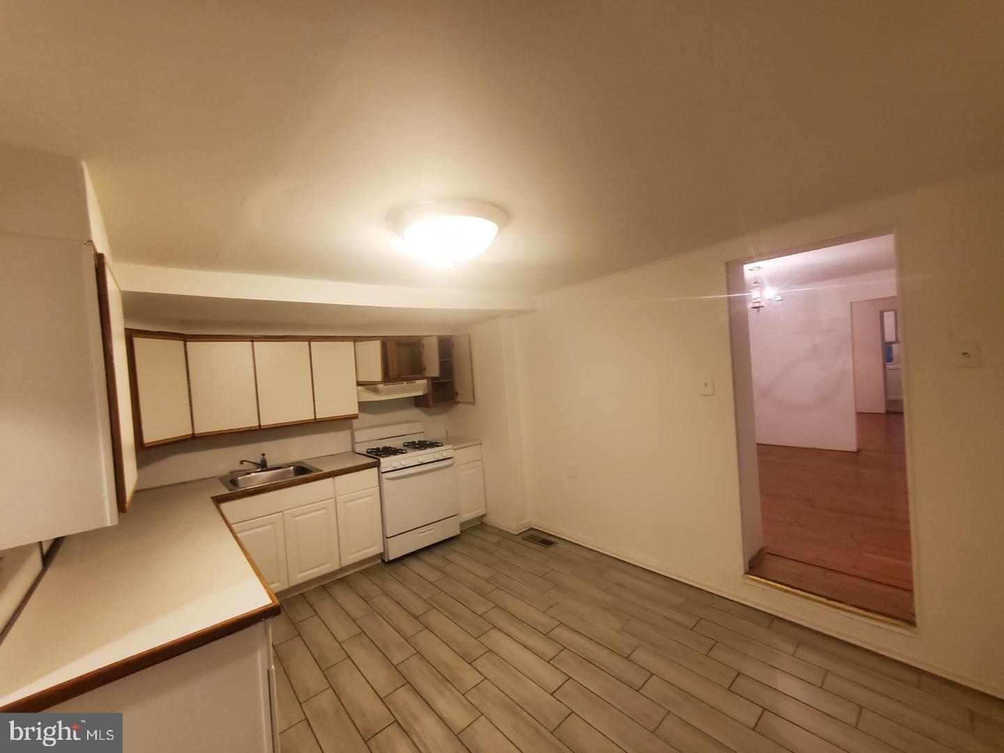 a kitchen with granite countertop a stove and cabinets