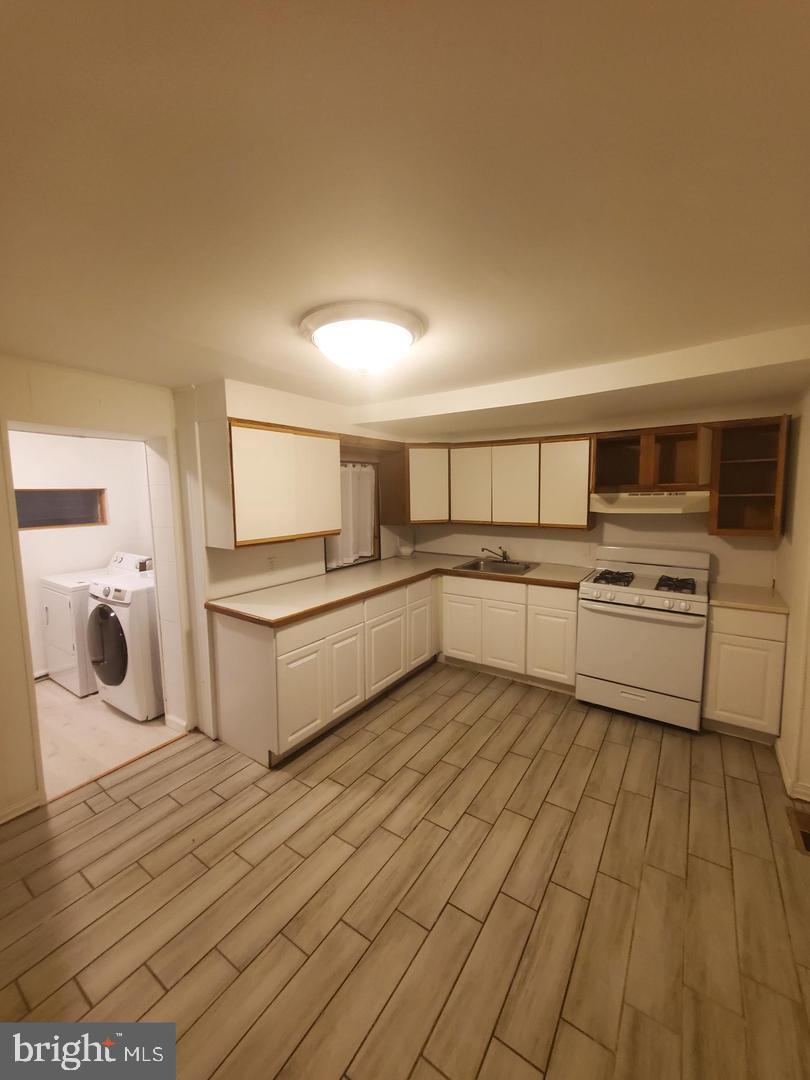 1 Old Ashton Road Philadelphia, PA 19152 - Photo 3 of 18 a large white kitchen with stainless steel appliances granite countertop a stove and a sink